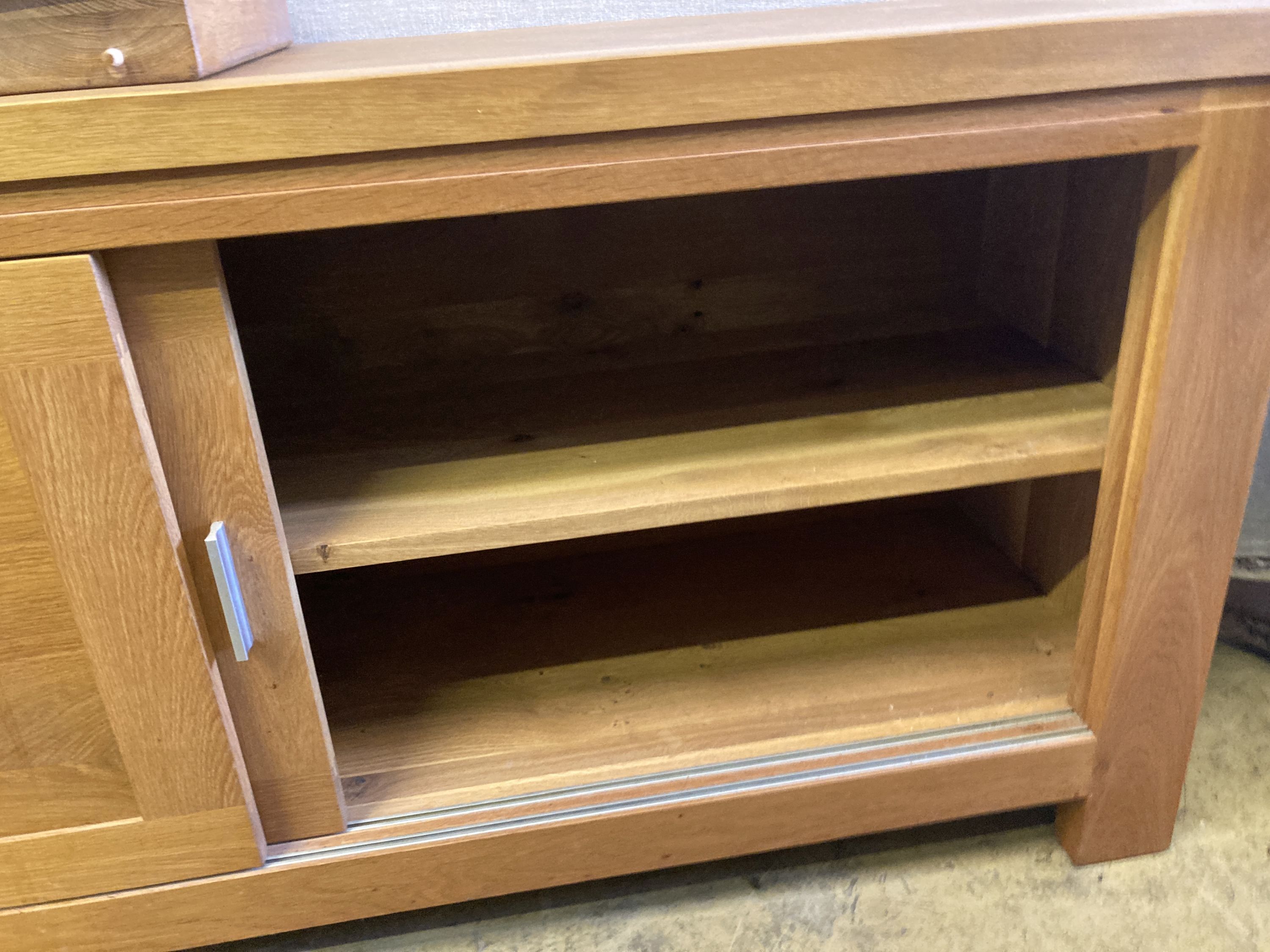 A contemporary oak dining suite,